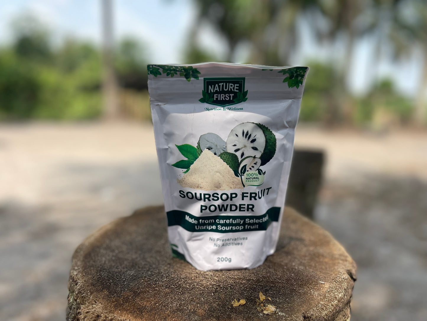 Package of Nature First Soursop Fruit Powder on a stone surface with a blurred natural background